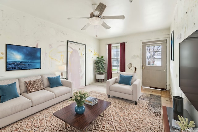 living area with a ceiling fan