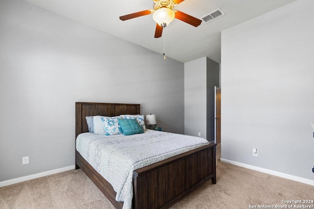 bedroom with baseboards, visible vents, vaulted ceiling, and light colored carpet