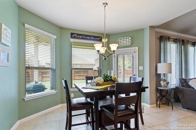 dining room with light tile patterned floors, a chandelier, and baseboards