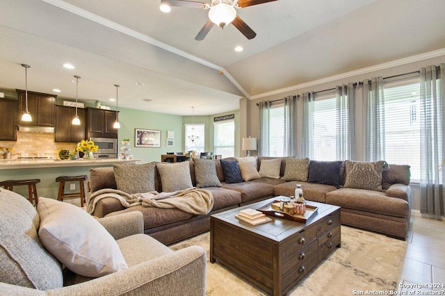 living room featuring ornamental molding, a ceiling fan, vaulted ceiling, and light tile patterned floors