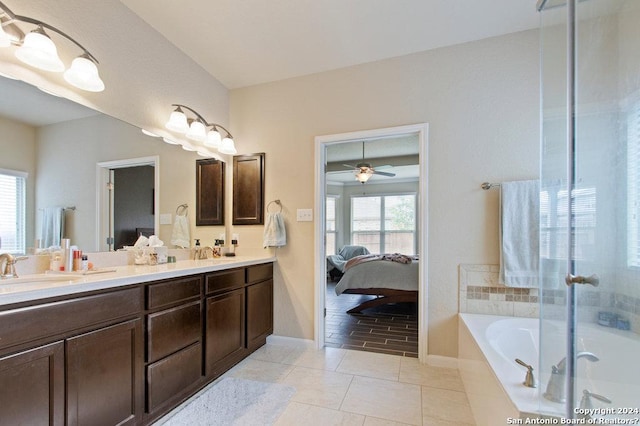 bathroom featuring ensuite bath, a sink, tile patterned flooring, a shower stall, and a bath