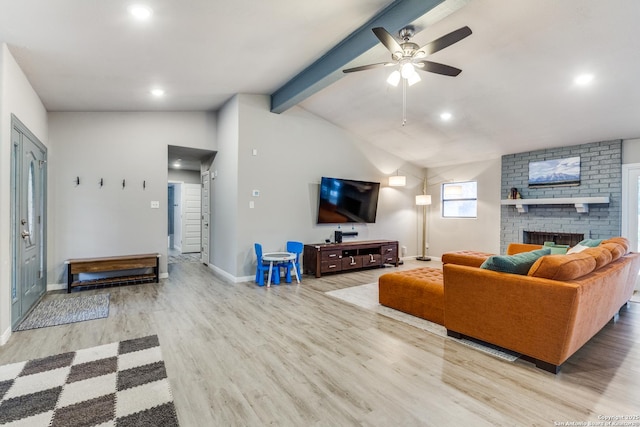 living room featuring vaulted ceiling with beams, recessed lighting, a brick fireplace, wood finished floors, and baseboards