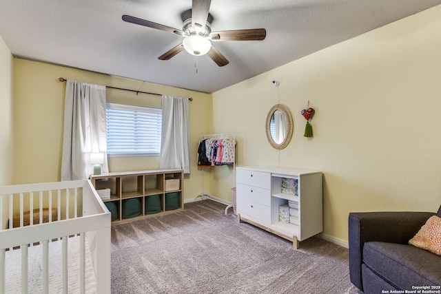 carpeted bedroom with ceiling fan and baseboards