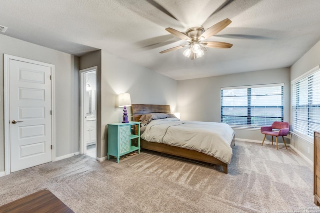 carpeted bedroom with a textured ceiling, ceiling fan, visible vents, and baseboards