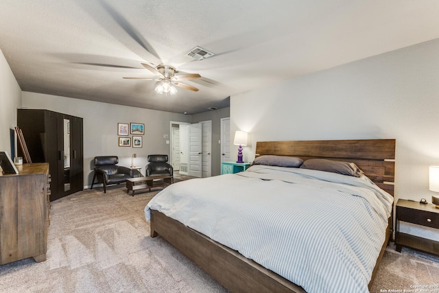 bedroom featuring light carpet, ceiling fan, and visible vents