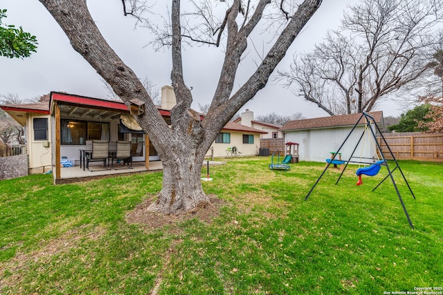 view of yard featuring a patio area, cooling unit, fence, and a playground