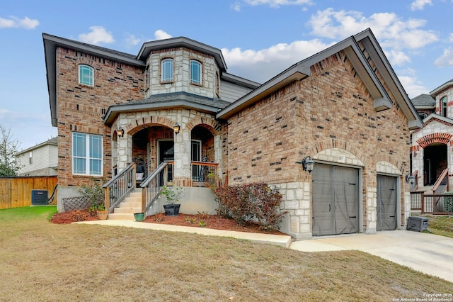 french provincial home featuring central AC unit, a garage, fence, concrete driveway, and a front lawn