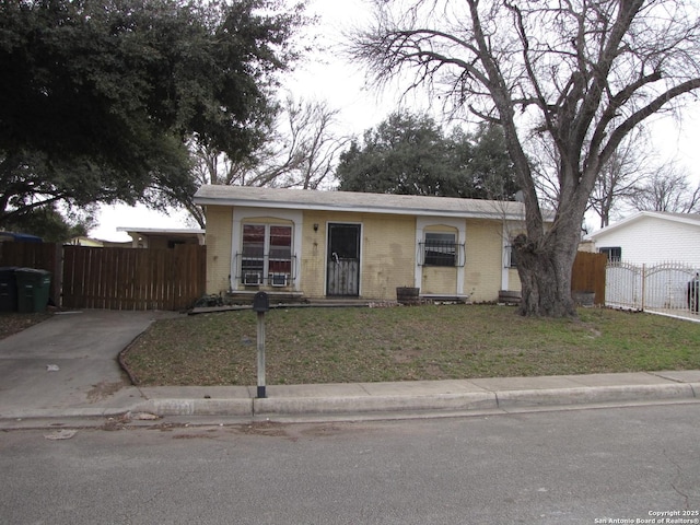 view of front of home featuring a fenced front yard, a front yard, and brick siding