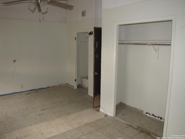 unfurnished bedroom featuring light floors, a ceiling fan, visible vents, and a closet