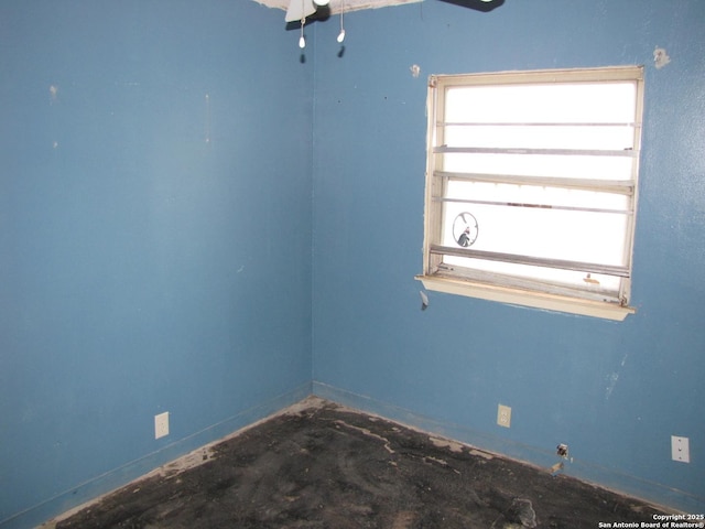 unfurnished room featuring unfinished concrete flooring