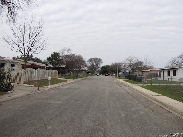 view of road featuring sidewalks, a residential view, and curbs