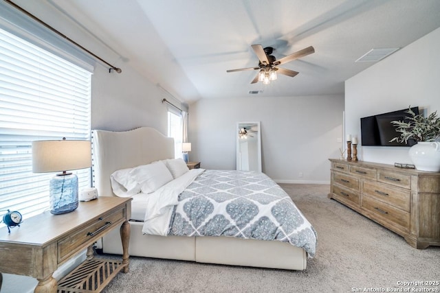 bedroom featuring baseboards, visible vents, a ceiling fan, and light colored carpet