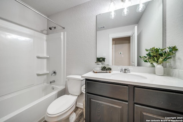 full bathroom with shower / bathtub combination, a textured wall, toilet, vanity, and visible vents