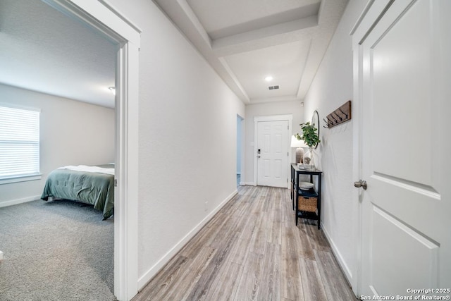 hallway featuring light wood-style floors and baseboards