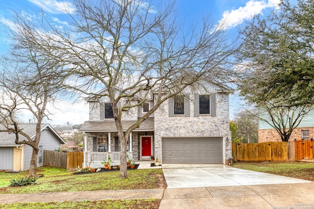 traditional-style house with driveway, a garage, fence, and a porch