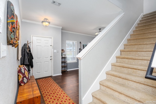 entryway featuring visible vents, baseboards, stairway, dark wood finished floors, and crown molding