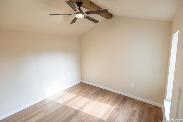 spare room featuring baseboards, vaulted ceiling with beams, light wood finished floors, and ceiling fan