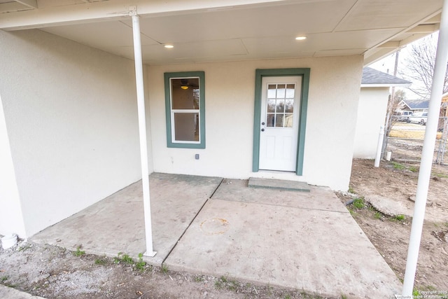 property entrance featuring stucco siding