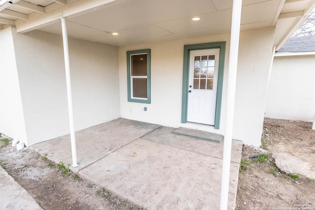 property entrance with stucco siding