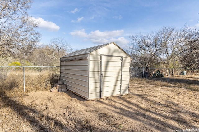 view of shed with fence