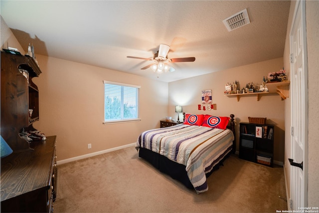 bedroom featuring a ceiling fan, light colored carpet, visible vents, and baseboards