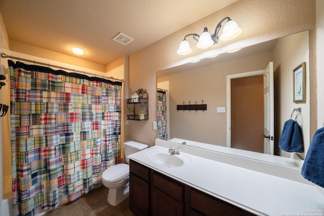 bathroom with visible vents, toilet, tile patterned flooring, a textured ceiling, and vanity