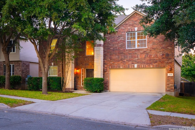 view of front facade featuring brick siding, driveway, and an attached garage