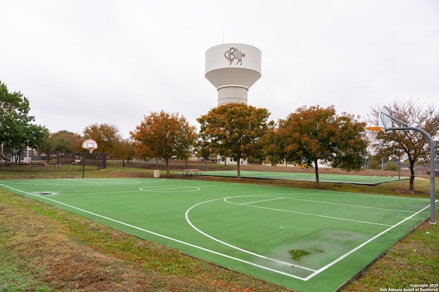 view of basketball court with community basketball court and fence