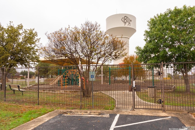 community playground featuring fence and a yard