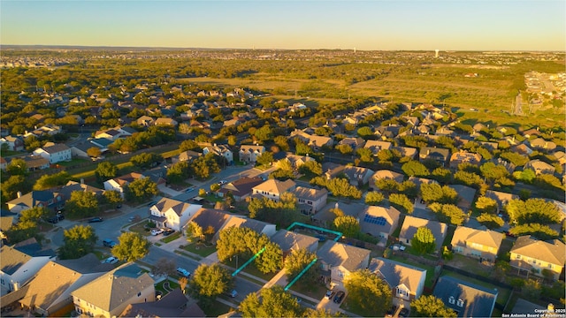 aerial view at dusk featuring a residential view