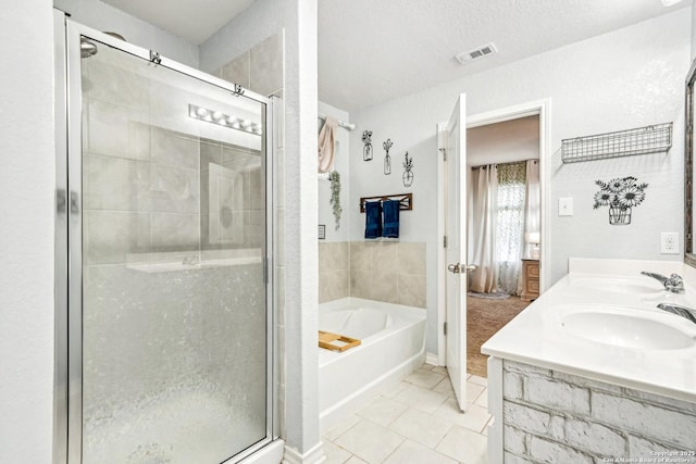 full bathroom featuring a sink, a stall shower, visible vents, and a bath