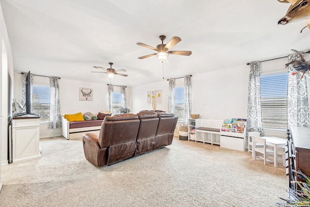 living area with carpet and ceiling fan