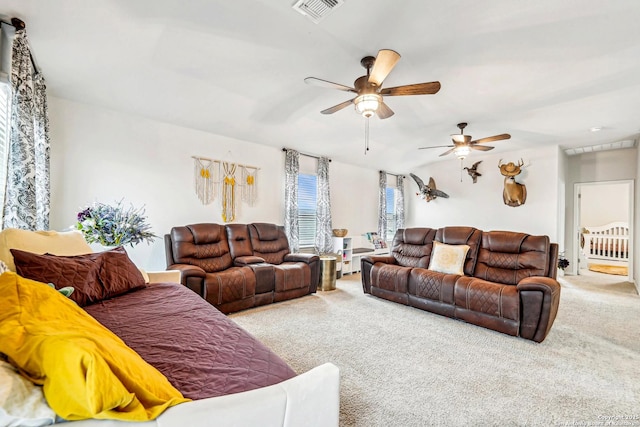 carpeted living room featuring ceiling fan and visible vents