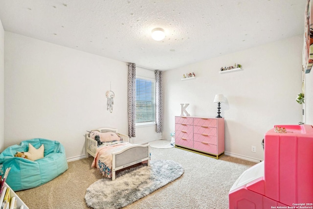 bedroom featuring light colored carpet, a textured ceiling, and baseboards