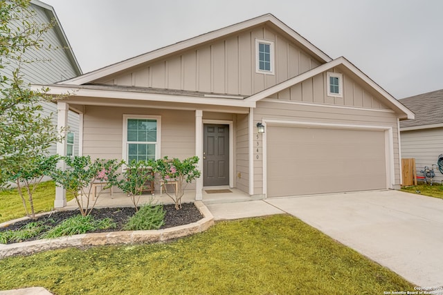 view of front of house with board and batten siding, a front yard, driveway, and a garage