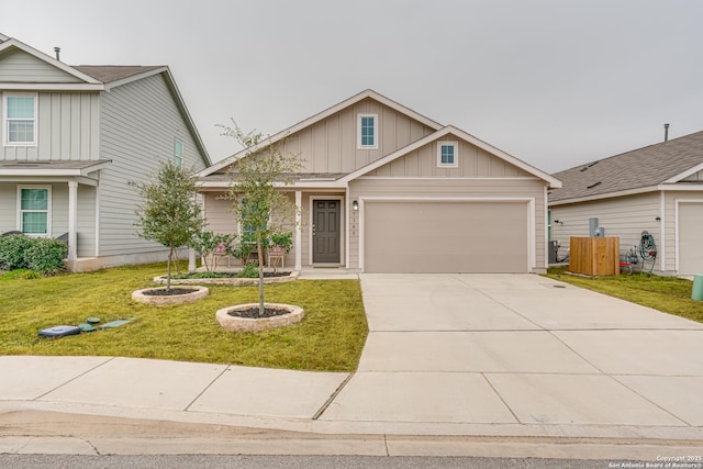 view of front of home featuring board and batten siding, a garage, concrete driveway, and a front yard