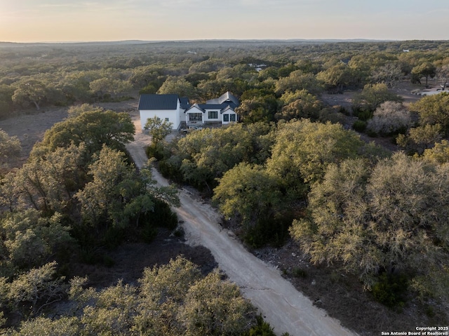 aerial view featuring a wooded view