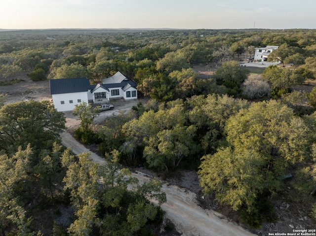 birds eye view of property with a wooded view