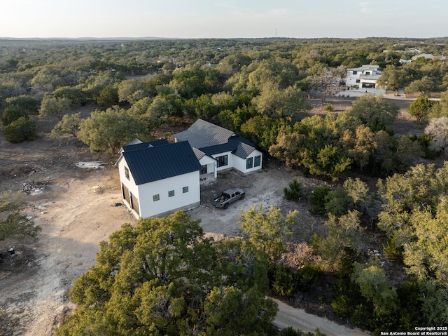 aerial view featuring a wooded view