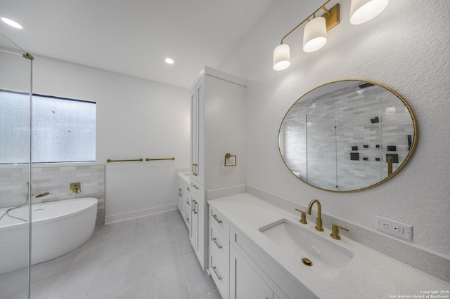 31047 Windmill Ln, Bulverde, TX 78163 - bathroom with vanity, tile patterned floors, a freestanding tub, a tile shower, and recessed lighting