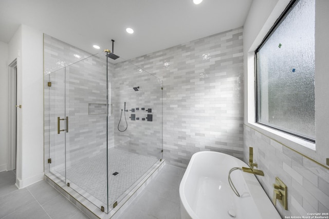 31047 Windmill Ln, Bulverde, TX 78163 - bathroom featuring tile walls, a stall shower, a soaking tub, tile patterned floors, and recessed lighting