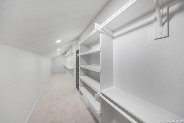 31047 Windmill Ln, Bulverde, TX 78163 - spacious closet featuring light carpet and vaulted ceiling