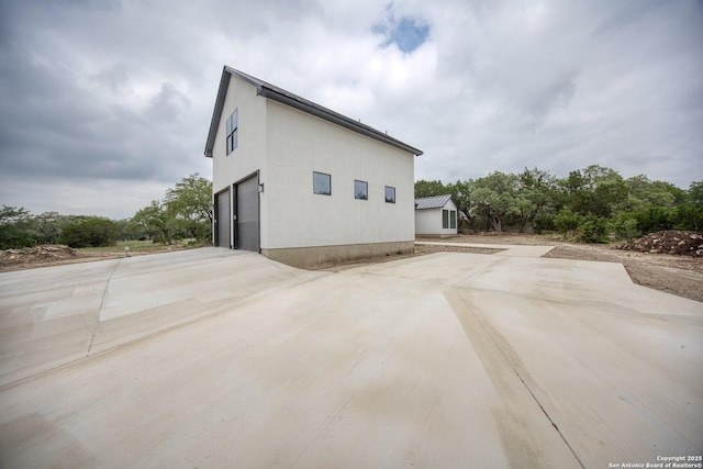 31047 Windmill Ln, Bulverde, TX 78163 - view of property exterior featuring a garage and concrete driveway