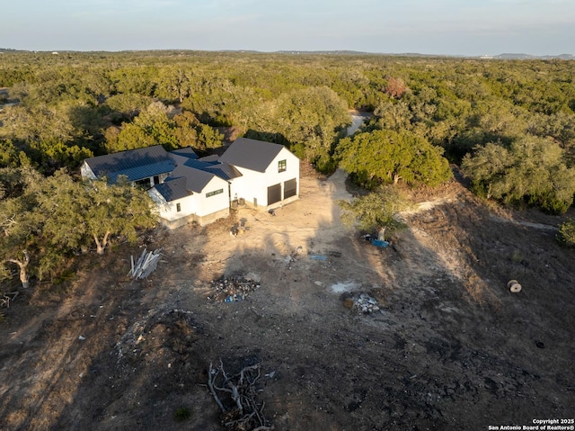 birds eye view of property with a view of trees