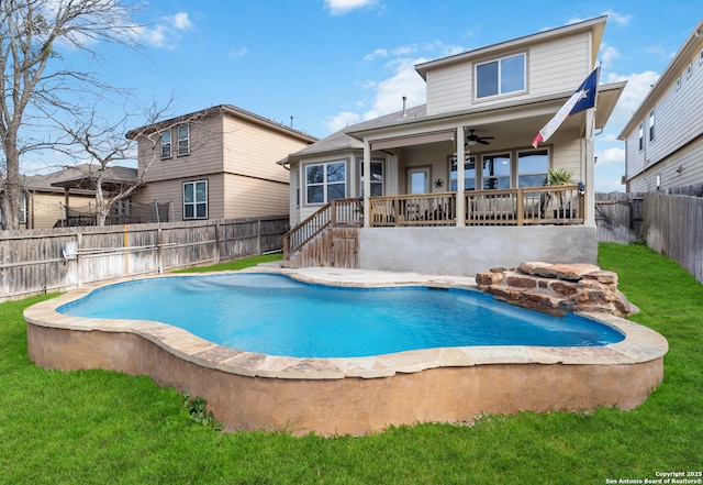 view of pool featuring a yard, a fenced backyard, a ceiling fan, and a fenced in pool