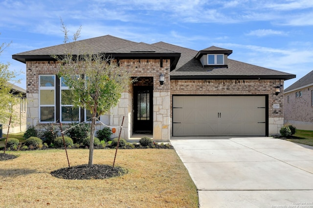 view of front of property with a garage, driveway, a shingled roof, a front lawn, and brick siding