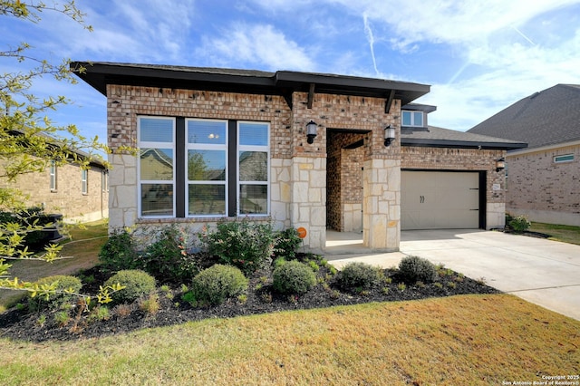 view of front of property with a garage, concrete driveway, brick siding, and a front lawn