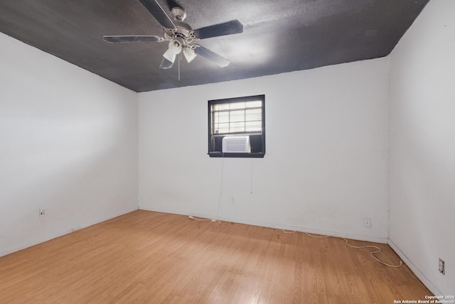 empty room featuring light wood-style floors, cooling unit, ceiling fan, and a textured ceiling