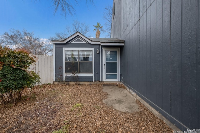 view of exterior entry with fence