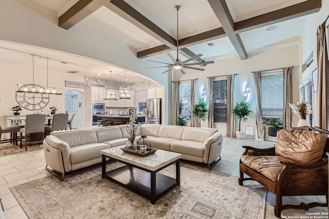 living room with arched walkways, beamed ceiling, light tile patterned flooring, and visible vents